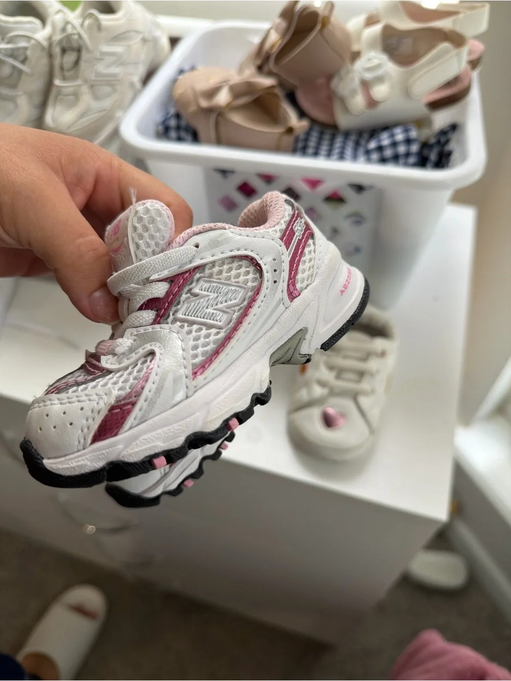 2 shoes . 1 New Balance White and Pink Kids Running Sneakers and 1 kurt geiger
